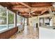 Inviting sunroom with a wood-paneled ceiling, tiled floor, and bright windows offering views of the backyard at 12306 91St Ter, Seminole, FL 33772