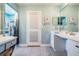 This well-lit bathroom features tile floors, vanity, and a walk-in closet accessible on the side at 13386 Lawrence St, Spring Hill, FL 34609