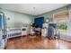 Green Bedroom with hardwood floors, a crib, changing table, and desk by the window at 13386 Lawrence St, Spring Hill, FL 34609