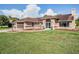 Inviting single-story home with a well-kept lawn and decorative landscaping in the front yard at 13386 Lawrence St, Spring Hill, FL 34609