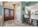 Inviting foyer featuring a decorative glass double door, stylish flooring, and access to the kitchen at 13386 Lawrence St, Spring Hill, FL 34609