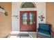 Inviting front entrance with double doors, decorative details, and a cozy sitting area at 13386 Lawrence St, Spring Hill, FL 34609