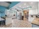 Open kitchen features stainless steel appliances, granite countertops, wood-look tile, and ample cabinetry at 13386 Lawrence St, Spring Hill, FL 34609