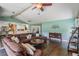 Spacious living area showcases a comfortable sectional, wood floors, and an open layout to the kitchen at 13386 Lawrence St, Spring Hill, FL 34609