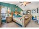 This spacious primary bedroom features elegant furnishings, tiled floors, and a decorative ceiling fan at 13386 Lawrence St, Spring Hill, FL 34609