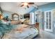 This spacious primary bedroom features elegant furnishings, tiled floors, and a decorative ceiling fan at 13386 Lawrence St, Spring Hill, FL 34609