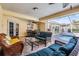 Outdoor patio with wicker seating, ceiling fan, and access to the screened-in pool at 13386 Lawrence St, Spring Hill, FL 34609