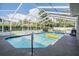Screened-in pool with patio furniture and a yellow raft, surrounded by a white privacy fence at 13386 Lawrence St, Spring Hill, FL 34609