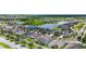 Aerial view of a suburban neighborhood with houses, a lake and tree-lined streets at 13913 Felix Will Rd, Riverview, FL 33579