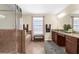 Bathroom showcasing a glass enclosed shower, soaking tub, double vanity, and decorative accents at 13913 Felix Will Rd, Riverview, FL 33579