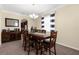 Traditional dining room with a wooden table set and a built-in cabinet featuring wine storage at 13913 Felix Will Rd, Riverview, FL 33579