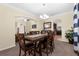 Open dining room with a large table, chairs, chandelier, and decorative arches at 13913 Felix Will Rd, Riverview, FL 33579