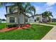 Beautifully landscaped front yard with lush green grass and mature palm trees at 13913 Felix Will Rd, Riverview, FL 33579