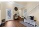 The bright foyer has wood floors, a staircase, and a decorative glass front door at 13913 Felix Will Rd, Riverview, FL 33579