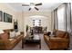 Comfortable living room features two sofas, a ceiling fan, and views of the dining room at 13913 Felix Will Rd, Riverview, FL 33579