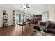 Cozy living room features wood flooring and views of the kitchen and fenced backyard at 13913 Felix Will Rd, Riverview, FL 33579