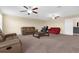 Spacious living room with two sofas, a coffee table and ceiling fans at 13913 Felix Will Rd, Riverview, FL 33579