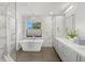 Stunning bathroom with marble wall, freestanding tub, shower, and a large window at 146 26Th Ne Ave, St Petersburg, FL 33704