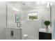 Modern bathroom with sleek glass shower, vanity with countertop and a bright window at 146 26Th Ne Ave, St Petersburg, FL 33704
