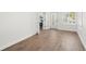 Spacious room with light-colored walls, wood flooring, and bright, natural light from many windows at 146 26Th Ne Ave, St Petersburg, FL 33704