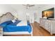Bright bedroom featuring a wooden dresser, hard wood floors, and a full bed at 146 26Th Ne Ave, St Petersburg, FL 33704