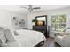 Bright bedroom featuring a bed, wooden dresser, and window with plantation shutters at 146 26Th Ne Ave, St Petersburg, FL 33704