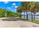 A paved boat ramp leading to Coffee Pot Park's calm waters, framed by palms and lush greenery, under a sunny, blue sky at 146 26Th Ne Ave, St Petersburg, FL 33704
