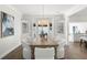 Elegant dining room with a rustic wood table, chic white chairs, and stylish pendant lighting at 146 26Th Ne Ave, St Petersburg, FL 33704