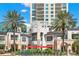 Charming downtown scene with palm trees, vibrant red umbrellas, and a modern building under a partly cloudy sky at 146 26Th Ne Ave, St Petersburg, FL 33704