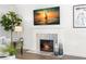 Close-up of the fireplace with a marble surround, a television, and tasteful decor at 146 26Th Ne Ave, St Petersburg, FL 33704