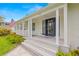 Home featuring a welcoming front porch, elegant door, and manicured landscaping at 146 26Th Ne Ave, St Petersburg, FL 33704