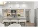 Modern kitchen featuring marble countertops, stainless steel appliances, and stylish bar seating at 146 26Th Ne Ave, St Petersburg, FL 33704