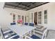 Outdoor dining on the patio with a white table, seating for six, and a black awning for shade at 146 26Th Ne Ave, St Petersburg, FL 33704