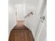 View looking down a wooden staircase with white walls and wooden handrail at 146 26Th Ne Ave, St Petersburg, FL 33704
