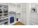 Spacious walk-in closet with custom shelving and a wooden floor at 146 26Th Ne Ave, St Petersburg, FL 33704
