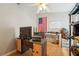 Bright bedroom featuring a ceiling fan, wood floors, American flag, shelves, and a workspace at 1502 Marsh Wood Dr, Seffner, FL 33584