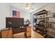 Bedroom area with a desk, shelves, ceiling fan, and an American flag on the wall at 1502 Marsh Wood Dr, Seffner, FL 33584