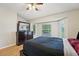 Cozy bedroom with wood floors, bay window, and large dresser with a mirror at 1502 Marsh Wood Dr, Seffner, FL 33584