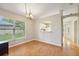 Dining area features wood-look tile floors and a view into kitchen at 1502 Marsh Wood Dr, Seffner, FL 33584