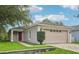 Charming single-story home with a two-car garage, well-maintained lawn, and beautiful landscaping at 1502 Marsh Wood Dr, Seffner, FL 33584