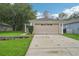 Charming single-story home with a spacious driveway, two-car garage, and manicured lawn at 1502 Marsh Wood Dr, Seffner, FL 33584