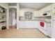 White kitchen features stainless steel sink, modern appliances, and tile floors at 1502 Marsh Wood Dr, Seffner, FL 33584