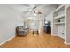 Inviting living room with hardwood floors, ceiling fan, built-in shelves, and a comfortable sofa at 1502 Marsh Wood Dr, Seffner, FL 33584