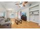 Inviting living room with hardwood floors, ceiling fan, built-in shelves, and a comfortable sofa at 1502 Marsh Wood Dr, Seffner, FL 33584