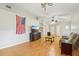 Open living room with vaulted ceiling, ceiling fan, and wood-look floors at 1502 Marsh Wood Dr, Seffner, FL 33584
