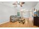 Inviting living room with hardwood floors, ceiling fan, built-in shelves, and a comfortable sofa at 1502 Marsh Wood Dr, Seffner, FL 33584