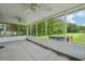 Spacious screened-in porch with views of the lush green backyard and plenty of natural light at 1502 Marsh Wood Dr, Seffner, FL 33584