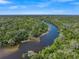 Gorgeous aerial view of a winding river flowing through lush greenery at 15415 Mulholland Rd, Parrish, FL 34219