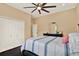 Cozy bedroom featuring a ceiling fan, natural light, closet, and a bed with striped linens at 15415 Mulholland Rd, Parrish, FL 34219