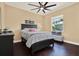 Comfortable bedroom with a ceiling fan, natural light, and wood floors at 15415 Mulholland Rd, Parrish, FL 34219